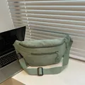Close-up of light green corduroy fanny pack with double zippers and adjustable strap - Light Green