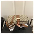 Close-up of vintage monogram shoulder bag with gold clasp and brown leather strap details - Style 2 Khaki