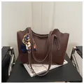 Brown faux leather tote bag with white contrast stitching and blue floral silk scarf - Coffee