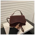 Chic burgundy leather crossbody bag with wave flap design and silver hardware - Red