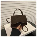 Mini dark brown suede crossbody bag with elegant curved flap and vintage texture - Coffee
