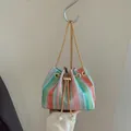 Rainbow woven straw bucket bag with gold chain strap and pearl drawstring detail - Pink