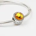 Silver snake chain bracelet featuring a round pendant with a faceted yellow gemstone charm - Yellow