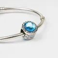 Silver snake chain bracelet with blue faceted gemstone and镂空 heart pattern - Sky Blue