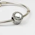 Silver snake chain bracelet with sparkling round charm and white gemstone inlay - White