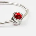 Silver bead charm with multifaceted red cat-eye stone and small crystal accents - Red