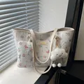 White floral tote bag with matching pouch and plush cloud charm on a sunny window sill - With Pendant / White