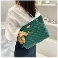 Detail of dark green quilted tote bag with gold chain strap and silk scarf accent - Green