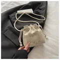 Beige knitted drawstring bucket bag with pink flower embroidery and tassel straps - Off White
