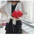 Detail of red lip-shaped crossbody bag in patent leather with gold chain strap - Red