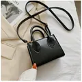 Detailed top view of black mini square bag with golden hardware and leather texture - Black