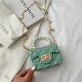 Mini mint green quilted crossbody bag featuring a large pearl handle and chain strap - Green