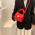 Red quilted small square crossbody bag with gold heart clasp and ruffled top handle - Red