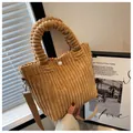 Brown corduroy bucket bag with textured handle and adjustable crossbody strap - Khaki