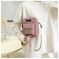 Detail of pink corduroy crossbody bag texture and branded logo with nylon strap - Pink