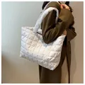 Detailed view of quilted puffer tote bag in white with square pattern stitching - White