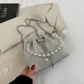 Silver rhinestone bucket bag with large pearl handle and metal chain strap - White