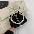 Sparkling black bucket bag with rhinestones, pearl handle and silver chain strap - Black