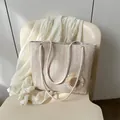 Beige woven straw tote bag featuring a 3D sunflower detail and thick cotton rope handles - White