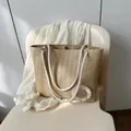 Chic beige straw tote bag with thick rope handles and a small white daisy charm - Khaki