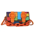Close-up of vibrant mosaic pattern crossbody bag with orange straps and chain detail - Orange