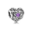 Macro shot of silver heart charm with scrollwork hollow pattern and purple gemstone - February (Purple)