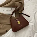 Borsa a spalla a mezzaluna rosso scuro con fibbia dorata e finitura in ecopelle liscia - Marrone Scuro