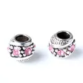 Macro shot of retro silver charms with pink rhinestones for DIY charm bracelets - Pink