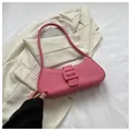 Detailed view of pink baguette bag with large buckle on minimalist blazer background - Rose Red