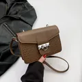 Brown faux leather crossbody bag with heart embossed texture and silver pyramid rivets - Brown