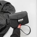 French style black crossbody bag featuring smooth leather and woven texture with silver rivets - Black