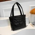 Minimalist black quilted puffer tote bag with thick handles for daily use - Black