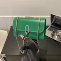 Green leather-textured crossbody bag with golden chain strap and U-shaped lock - Green