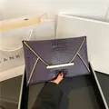 Fashion envelope clutch bag in dark purple crocodile pattern with gold metal trim - Purple