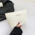 Portable cream heart-quilted makeup bag featuring FASHION BAG label and hand strap - White