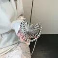 Silver metallic heart handbag with shell-texture finish and beaded top handle - Silver