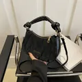 Classic black crescent handbag with pleated faux leather finish and knotted handle - With Pendant / Black