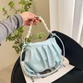 Light blue pleated cloud bag featuring pearl handle and detachable leather strap - Blue