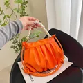 Bright orange pleated cloud bag with pearl handle and woven rope crossbody strap - Orange