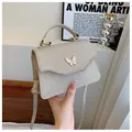 Sac à main tissé doré élégant avec boucle papillon et fine bandoulière réglable - Or