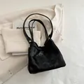 Minimalist black drawstring bucket bag with vintage suede texture and dual leather straps - Black
