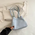 Chic light blue drawstring bucket bag with soft leather texture and slim dual handles - Blue