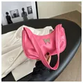 Detailed shot of pink PU leather underarm bag featuring a silver metal butterfly buckle - Pink