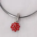 Macro detail of red floral charm with oil-drop petals and sparkling center rhinestone - Red