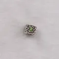 Detailed close-up of a square silver charm bead featuring rose relief and a green crystal - Light Green