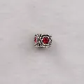 Macro detail of antique silver rose bead with a vibrant red crystal for DIY bracelets - Red