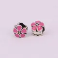 Detailed macro view of two pink enamel cherry blossom charms with silver alloy plating - Rose Red