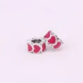 Macro detail of silver alloy heart-shaped beads with pink enamel for DIY jewelry making - Rose Red