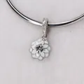 Macro detail of silver floral charm with white enamel petals and center rhinestone - White