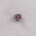 Detailed view of silver rose bead charm with pink crystal inlay and openwork design - Rose Pink